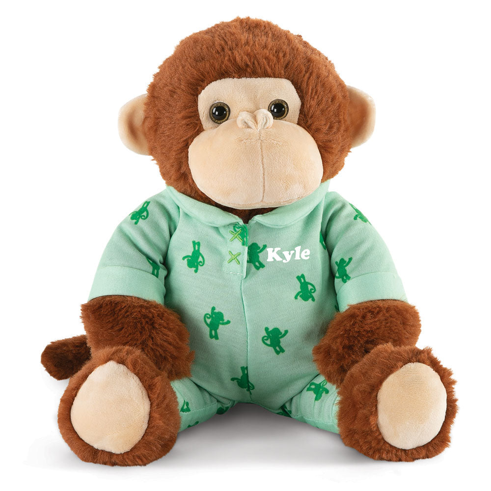 Brown plush monkey wearing green pajamas with cactus prints and the name "Kyle" embroidered on the chest.