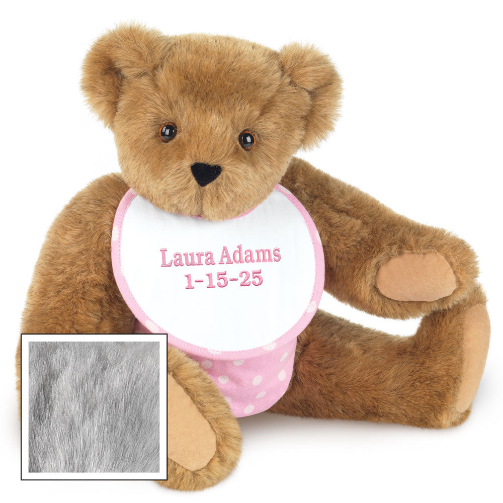 Small honey brown plush baby bear with black eyes and personalized pink bib embroidered with name and date.