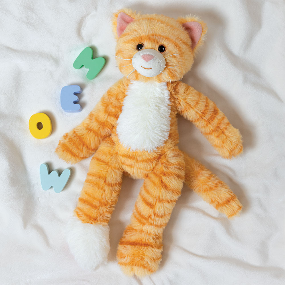 Orange and white striped plush kitten with four legs and embroidered face on white fabric background.