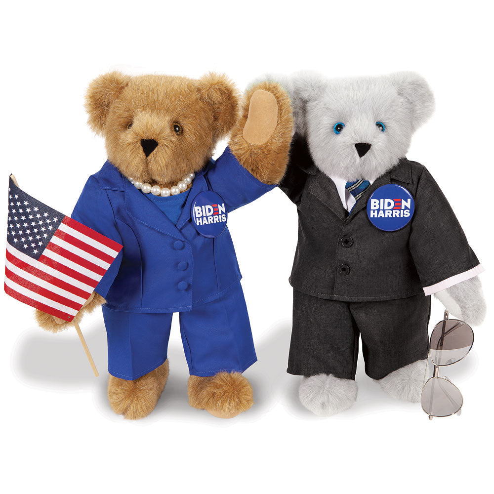 Two teddy bears dressed as Joe Biden and Kamala Harris, one in a blue suit with pearl necklace holding an American flag, the .