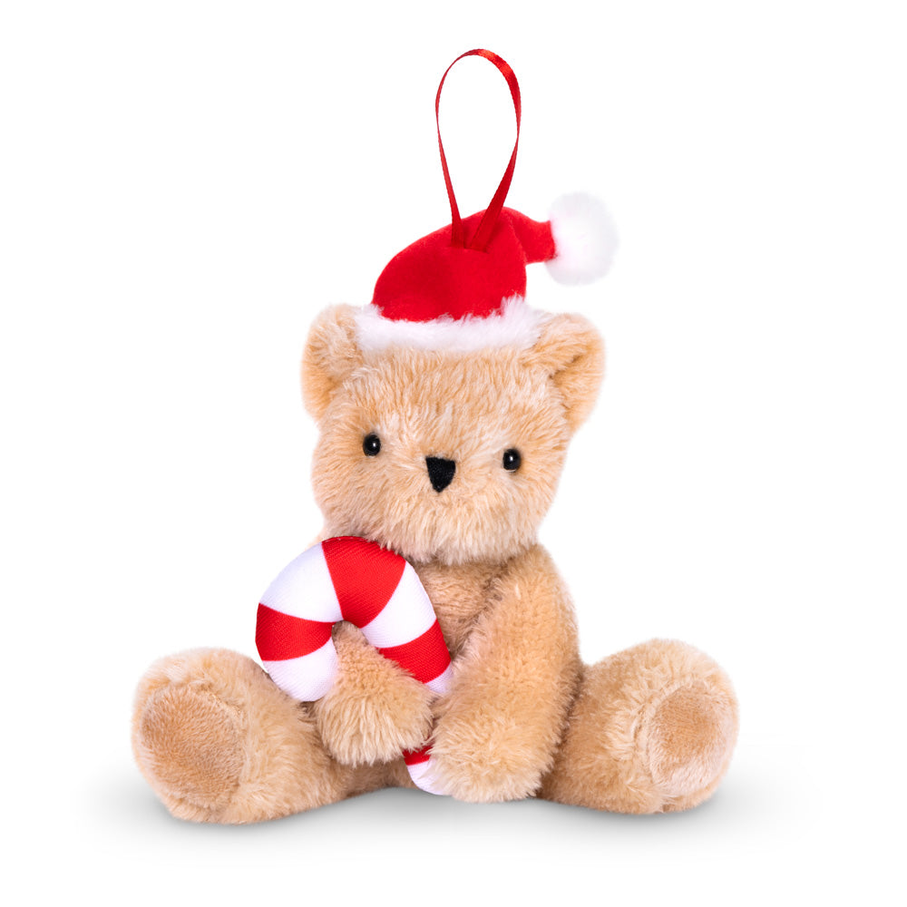 Plush teddy bear wearing red Santa hat holding red and white candy cane ornament with hanging loop.