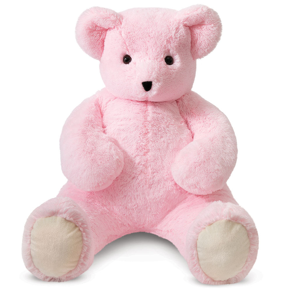 Large pink plush bear with beige paw pads and black eyes and nose sitting upright.