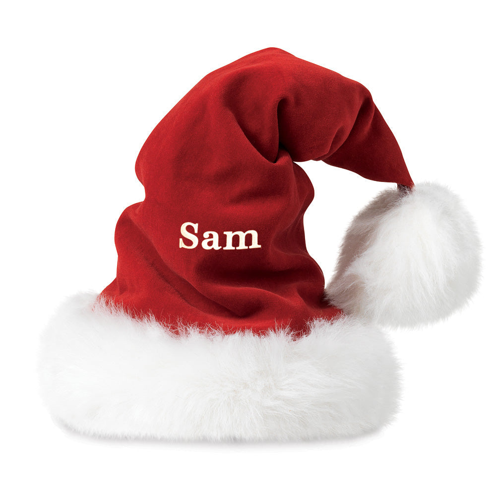 Red Santa hat with white faux fur trim and fluffy pom-pom, personalized with "Sam" in white letters.