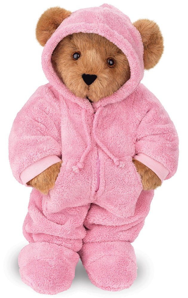 Brown teddy bear dressed in a plush pink hoodie footie outfit with hood and matching slippers.