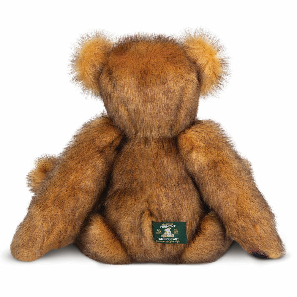 15-inch brown fluffy Vermont flannel bear plush with dark green fabric tag on back.