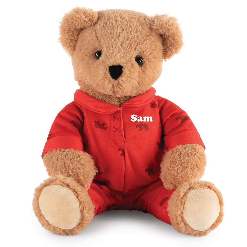 Light brown plush teddy bear wearing red pajamas with "Sam" embroidered on the chest.