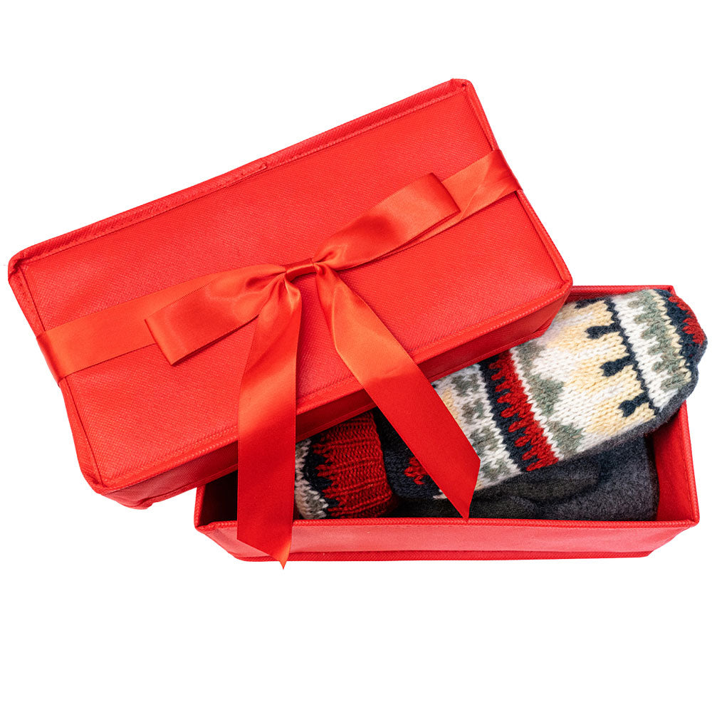 Red rectangular gift box with satin ribbon bow, containing folded knit patterned socks.