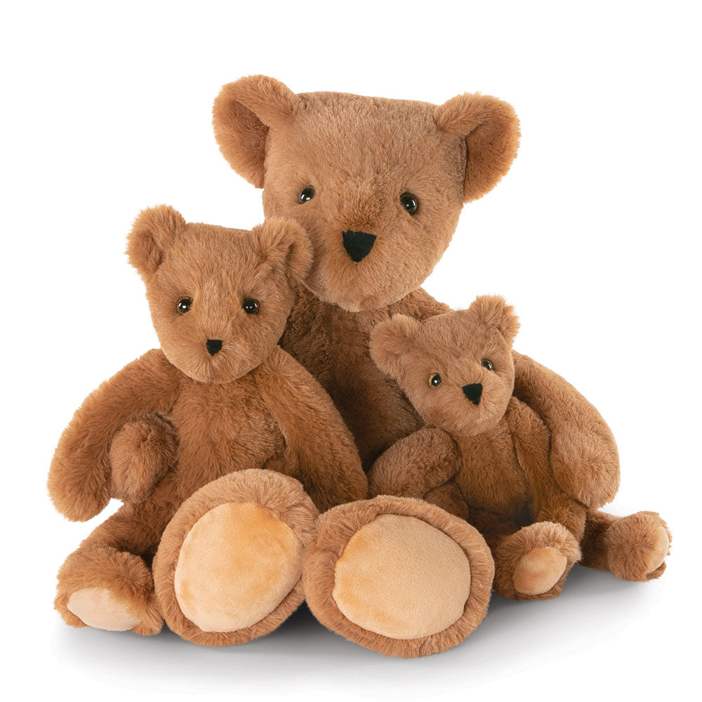 Three brown plush bears of different sizes with tan paw pads and black eyes and noses.