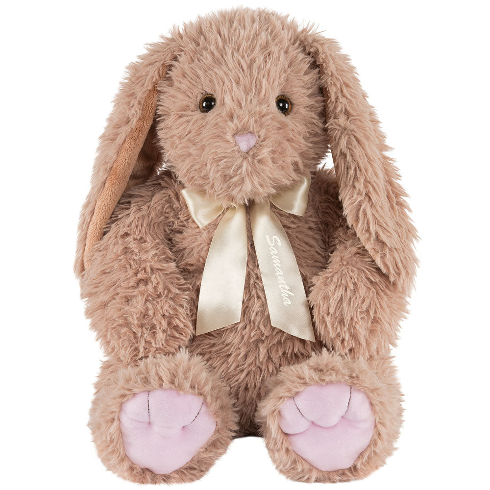 Plush light brown bunny with floppy ears, pink paw pads, and cream satin bow around neck.