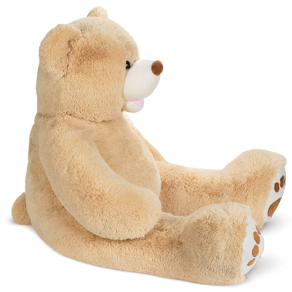 Light brown plush teddy bear sitting upright with white snout and paw pads with brown accents.