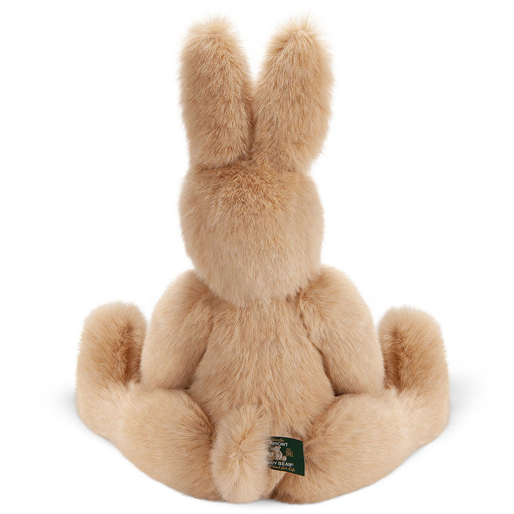 Soft beige plush bunny rabbit with long upright ears sitting with limbs spread out.