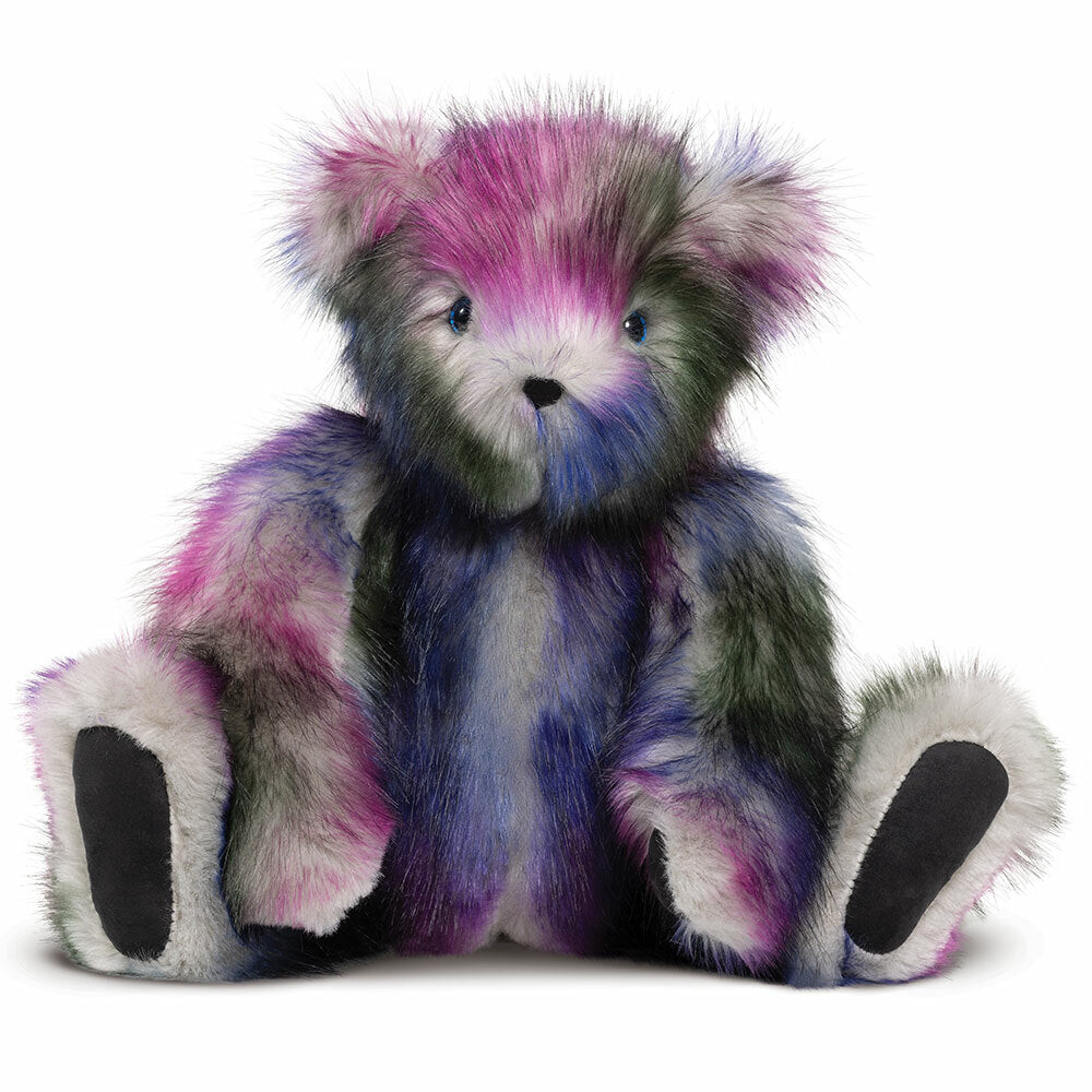 Plush teddy bear with multicolor galaxy-themed fur in purple, pink, and blue tones, black paw pads, and a soft texture.