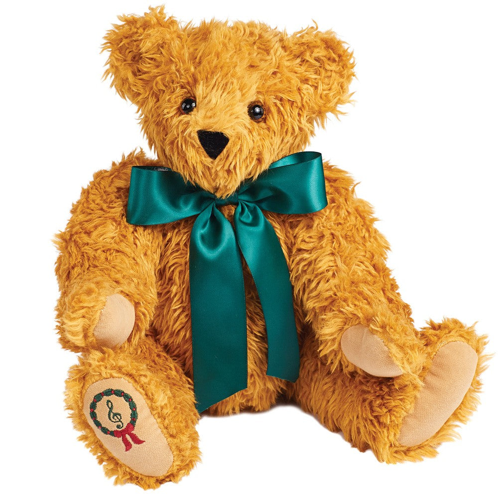 15-inch vintage-style teddy bear with curly golden fur, green satin bow, and embroidered musical note on paw.