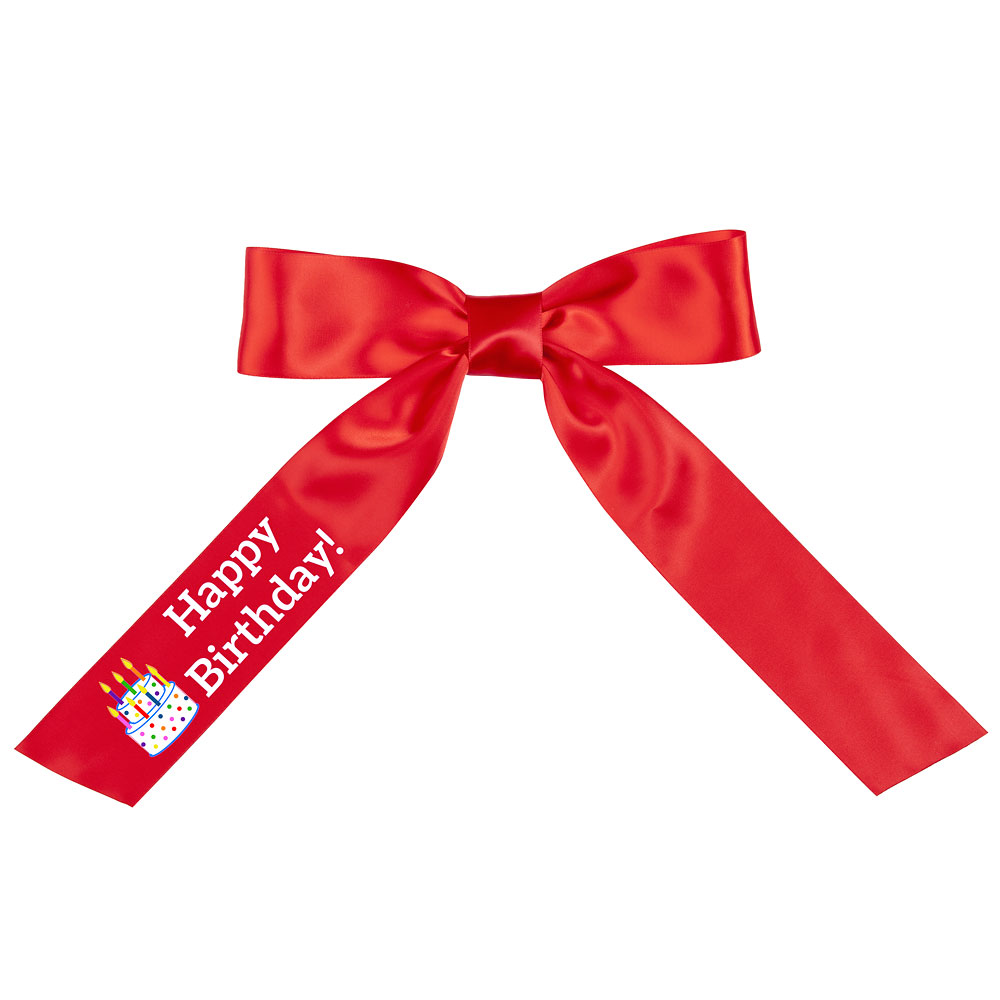 Red satin bow with long tails, "Happy Birthday" text and a colorful cupcake graphic on one tail.