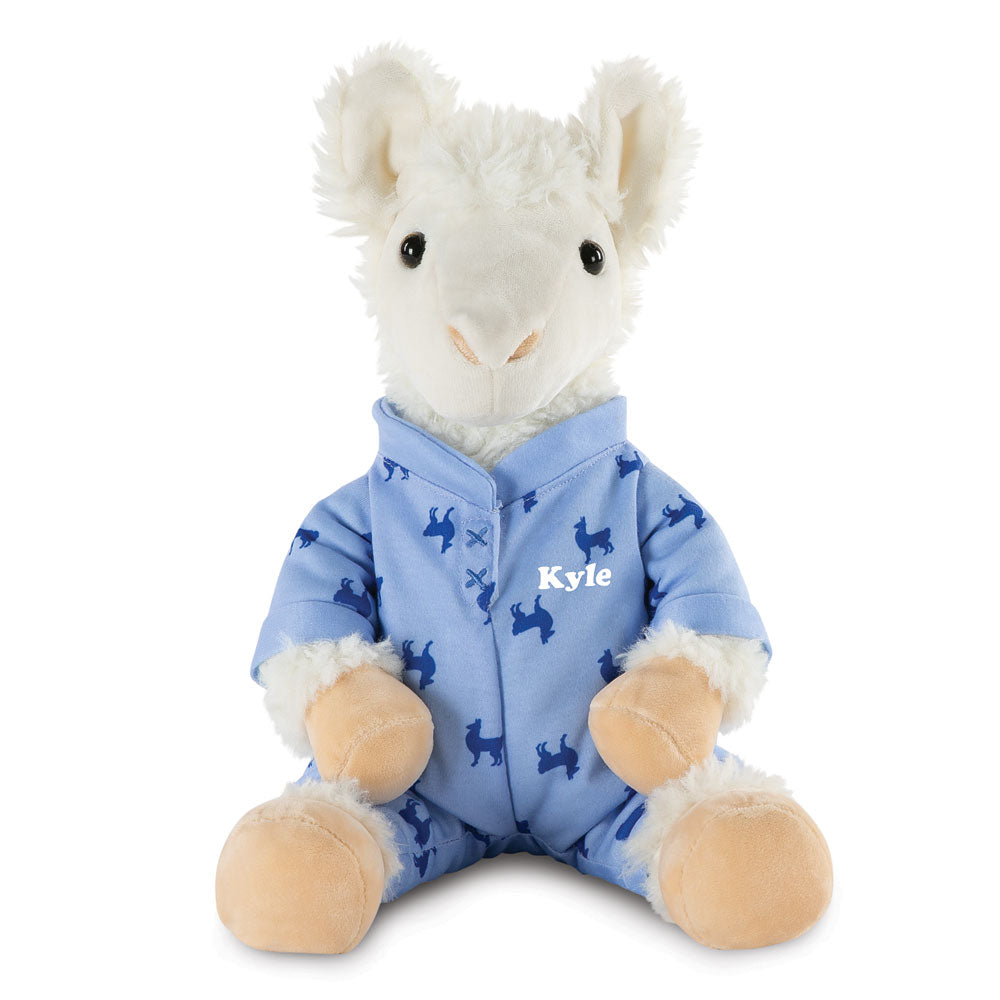 White plush llama wearing blue pajama onesie with dark blue llama patterns and "Kyle" embroidered on chest.