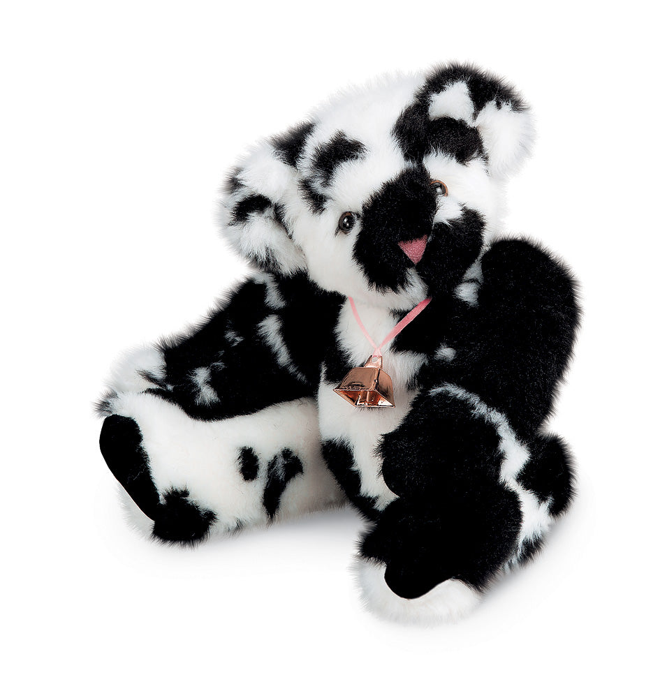 15-inch black and white spotted plush bear with a pink ribbon and bell around its neck.