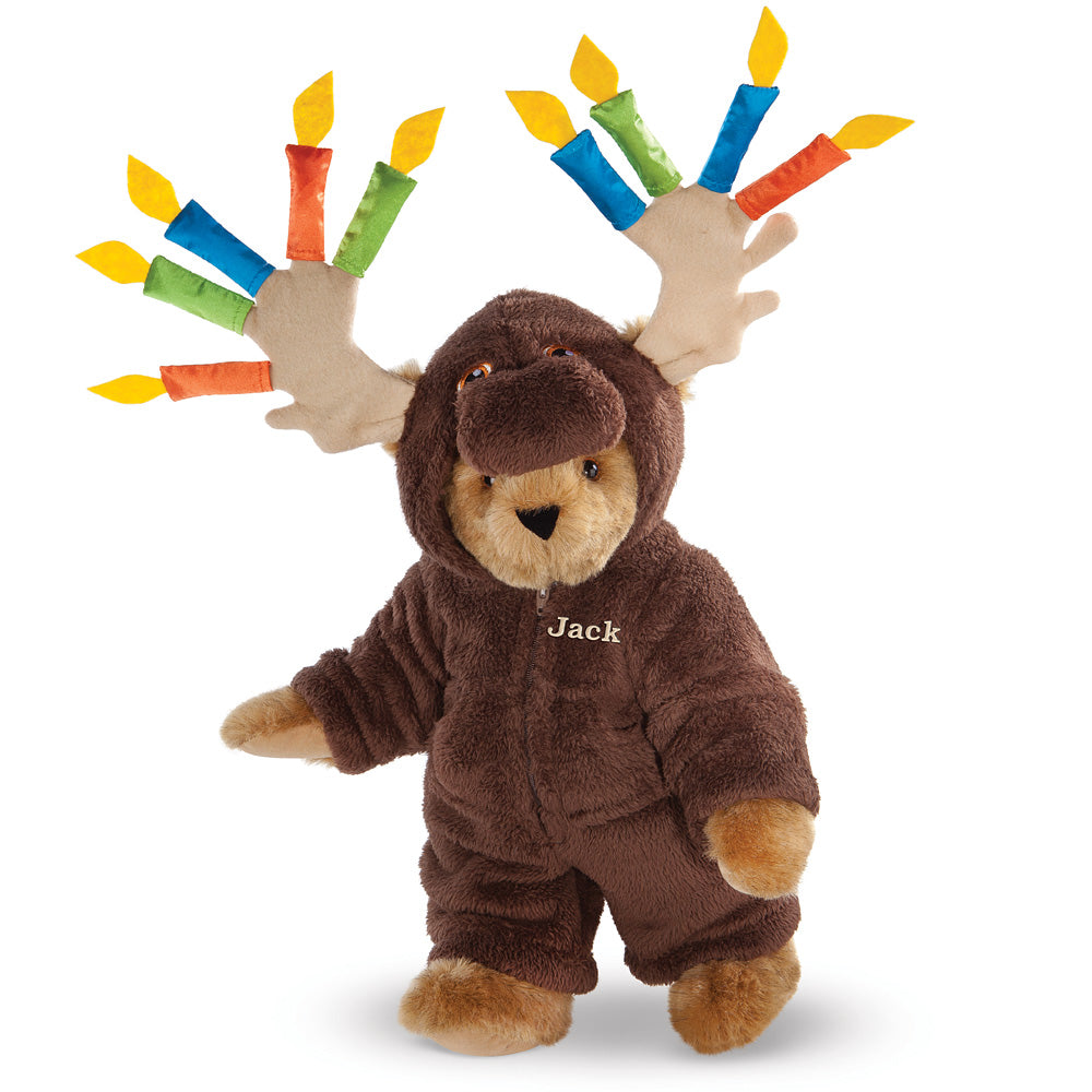 Brown plush bear wearing a moose costume with colorful birthday candles on antlers and "Jack" embroidered on chest.