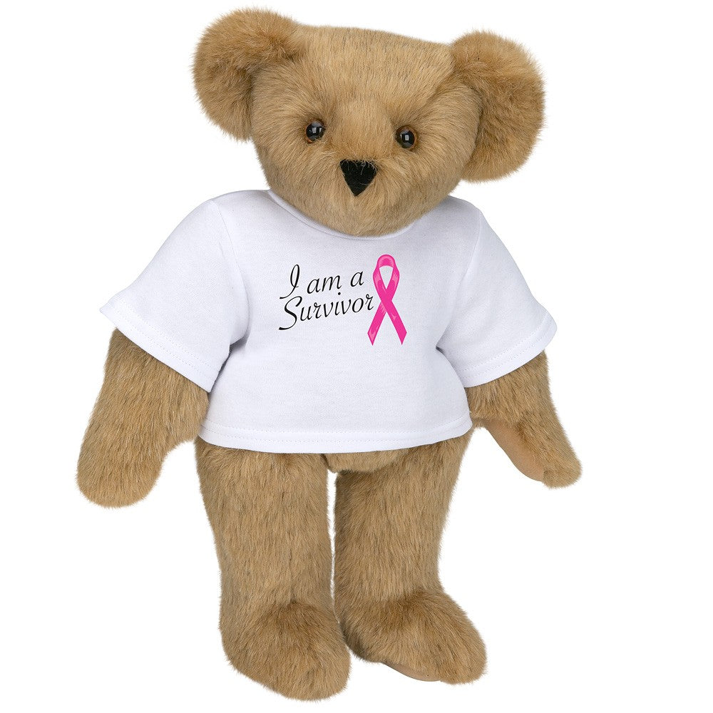 Light brown teddy bear wearing a white t-shirt with "I am a Survivor" and a pink breast cancer ribbon design.