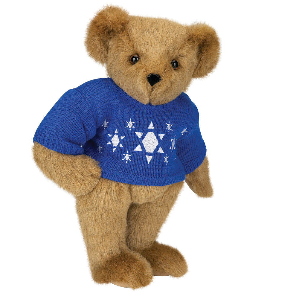 15-inch light brown teddy bear wearing a blue sweater with white Star of David and menorah patterns.