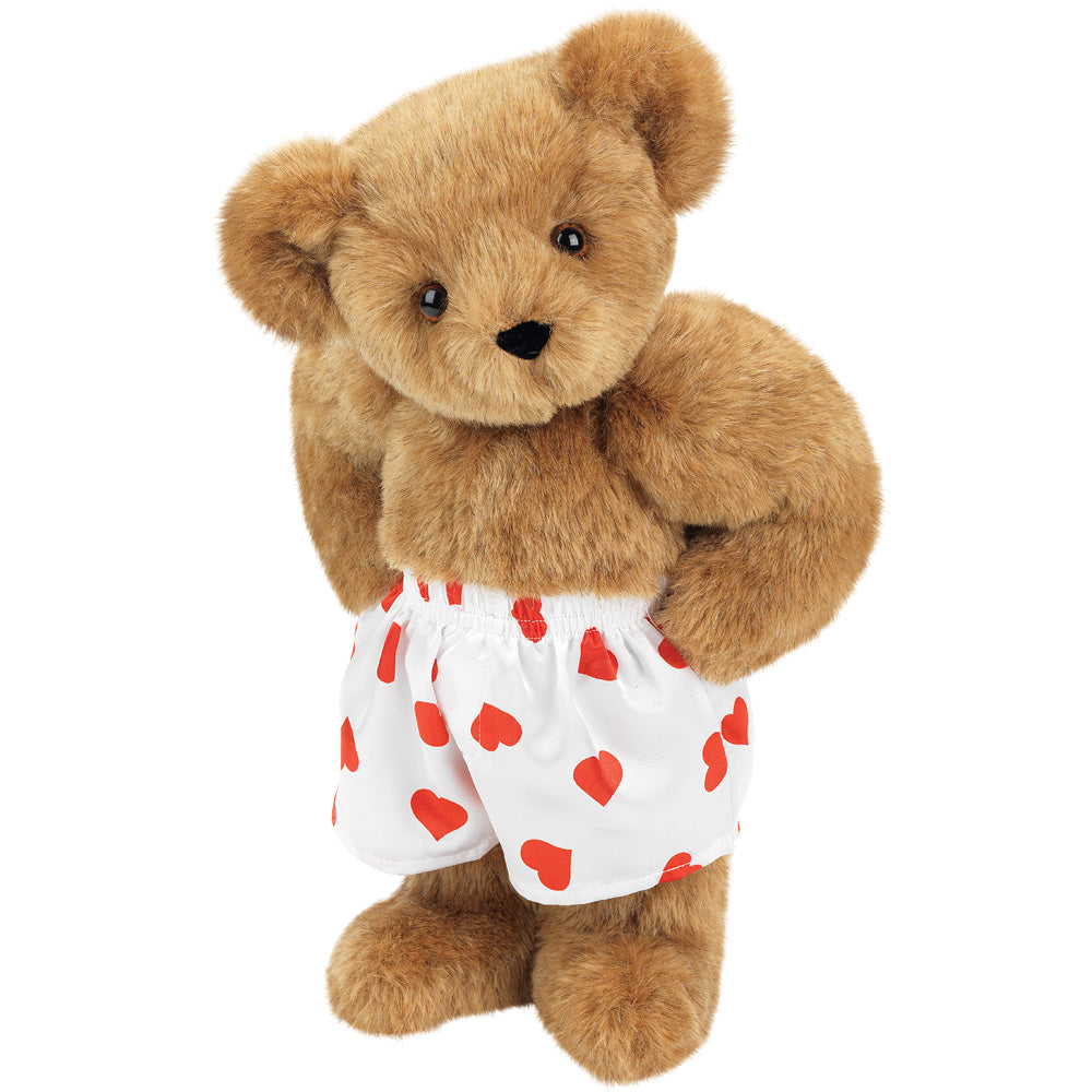 Light brown plush teddy bear wearing white shorts with red heart patterns.