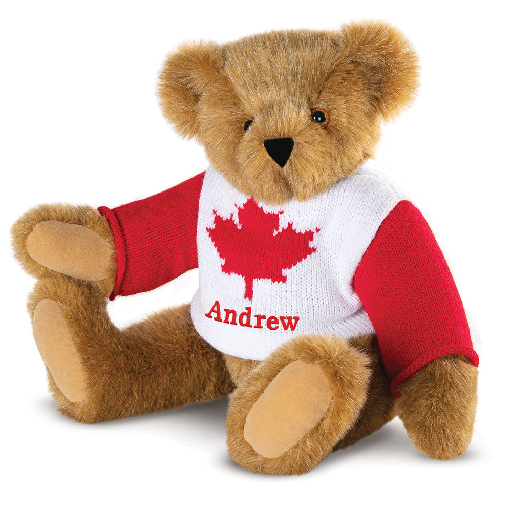 Brown teddy bear wearing a white sweater with a red maple leaf and red sleeves, personalized with the name Andrew.