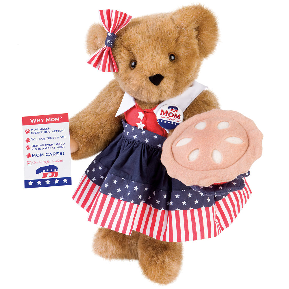 15-inch brown teddy bear wearing red, white, and blue star-spangled dress with a patriotic bow and holding a pie plush.