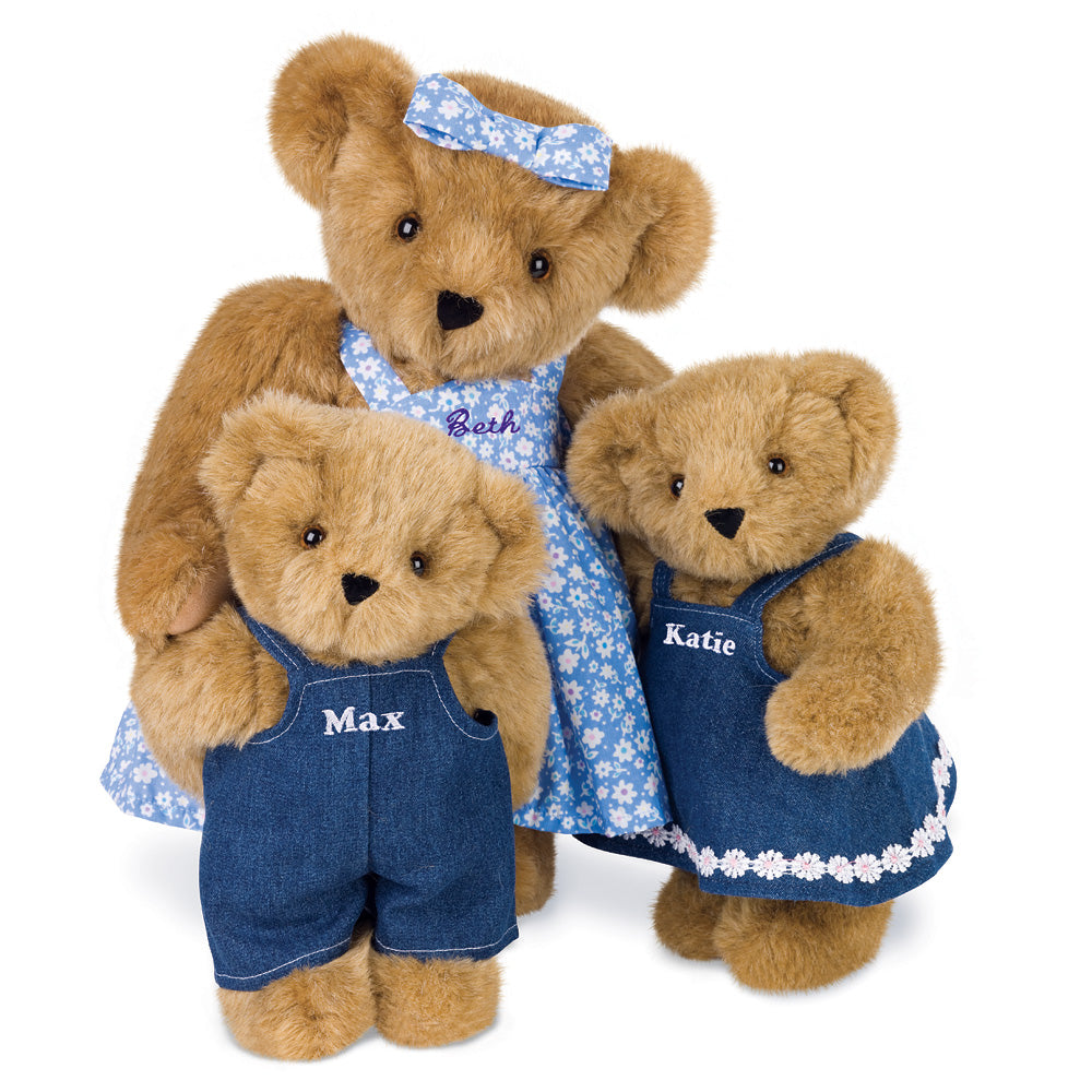 Three plush brown bears, a mother in a blue floral dress with headband, and two cubs in denim outfits labeled Max and Katie.