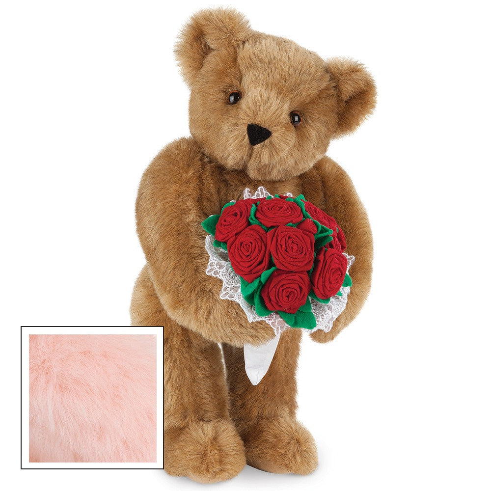 Honey brown plush teddy bear holding a bouquet of red fabric roses with green leaves and white lace trim.