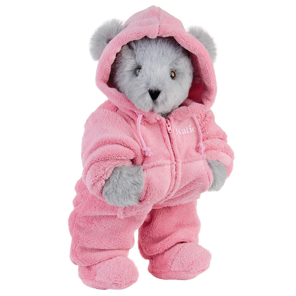 Gray plush bear wearing a soft pink hooded footie suit with front zipper and embroidered detail.