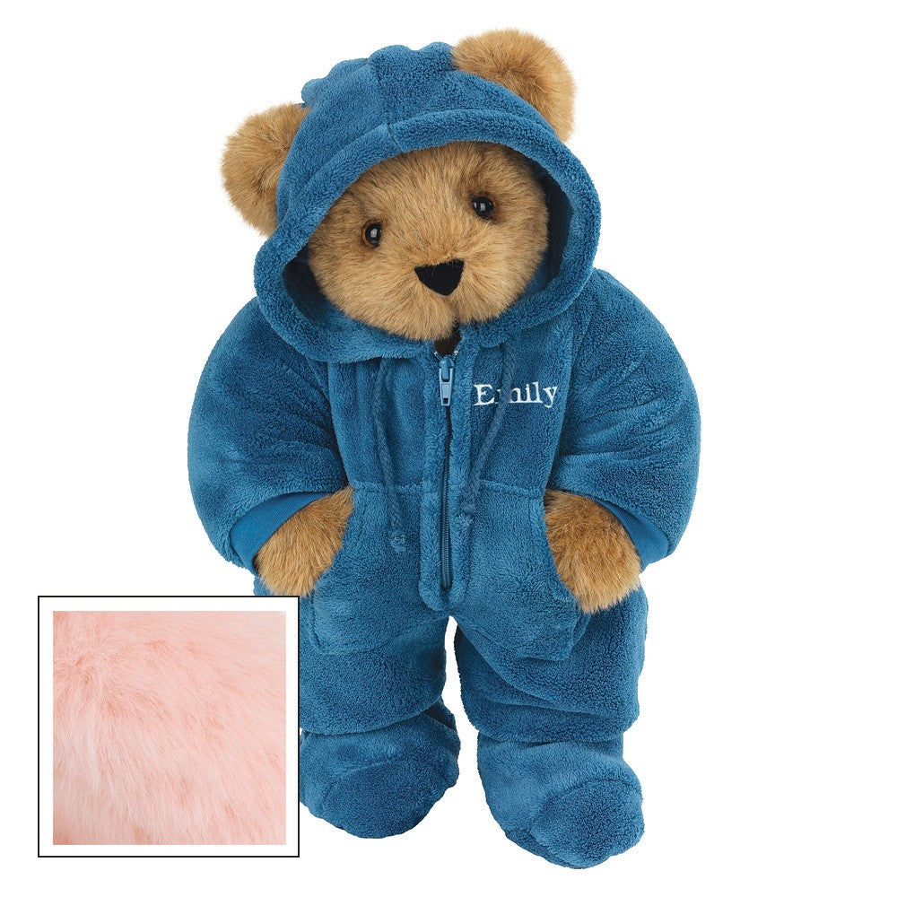 Honey-colored teddy bear wearing a blue hooded footie with embroidered name and paw pockets.