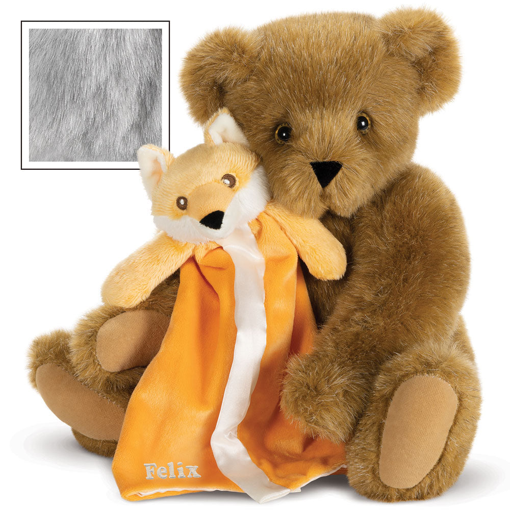Brown plush teddy bear holding orange fox-themed soft blanket with white trim and fox face head labeled Felix.