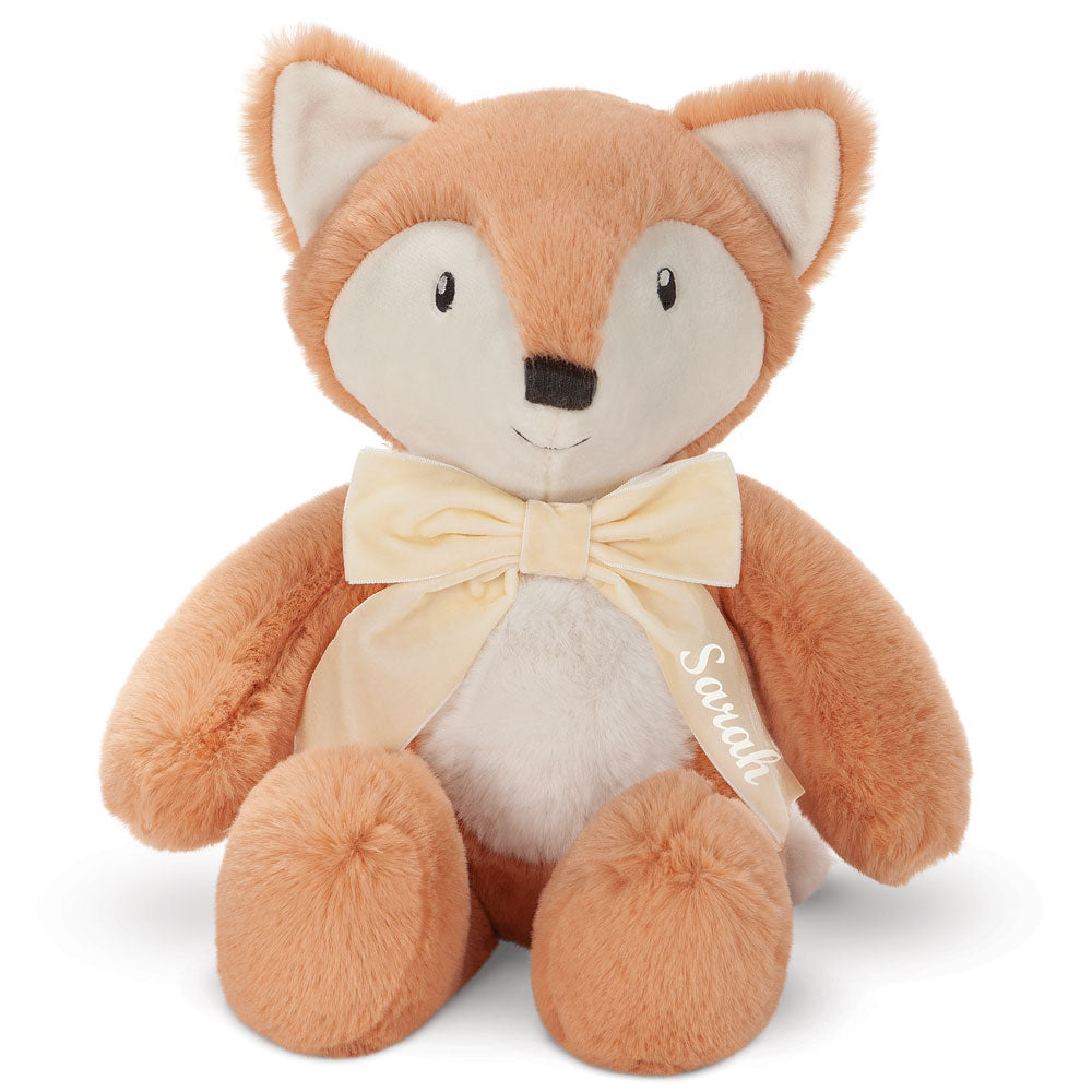 Soft plush fox with light orange fur, white belly and face, black eyes, and cream bow tie.