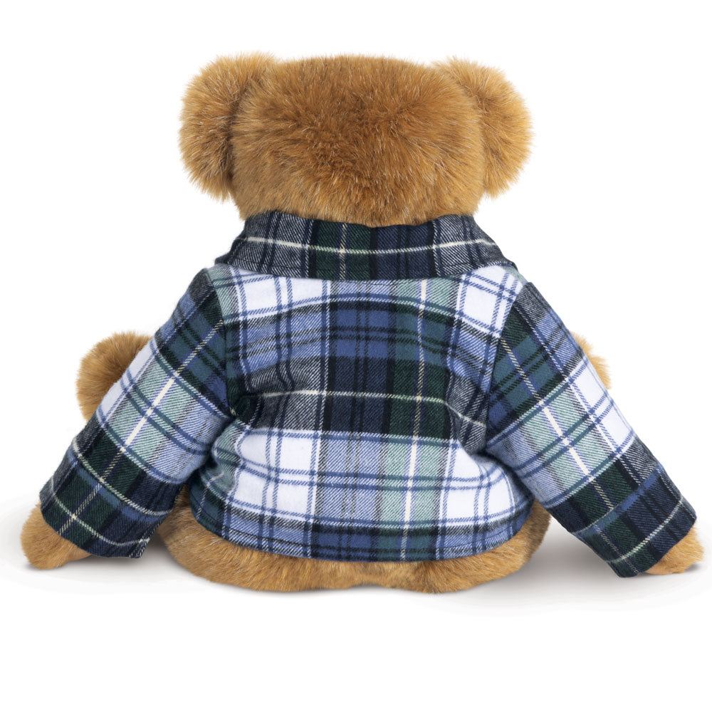Teddy bear wearing blue, white, and black Campbell plaid flannel jacket, sitting with back facing forward.