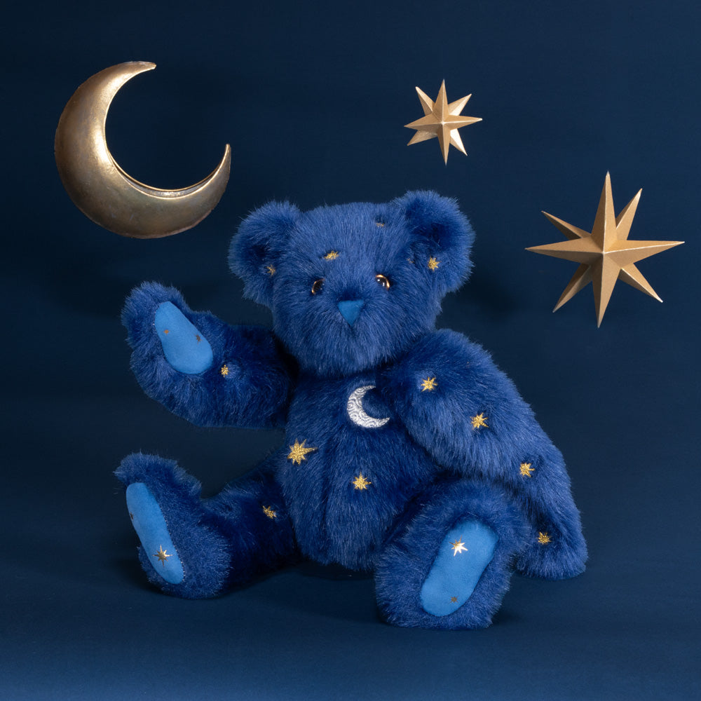 15-inch blue plush bear with celestial moon and star embroidery, sitting against dark blue background.