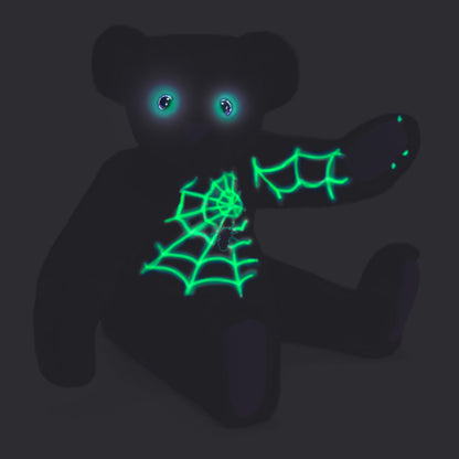 Black teddy bear with glow-in-the-dark spider web design and eyes