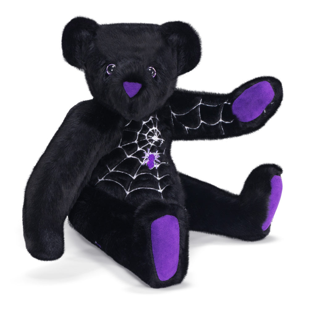 Front view of Spider web teddy bear with purple accents, glow in the dark eyes, and web design