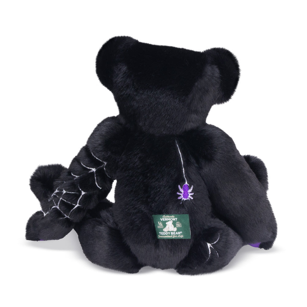 Back of Black teddy bear with purple and glow in the dark spiderweb design