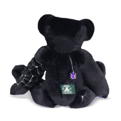 Back of Black teddy bear with purple and glow in the dark spiderweb design