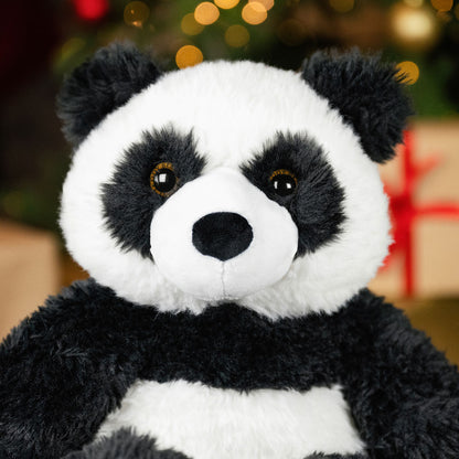 Plush panda toy with a blurred festive background