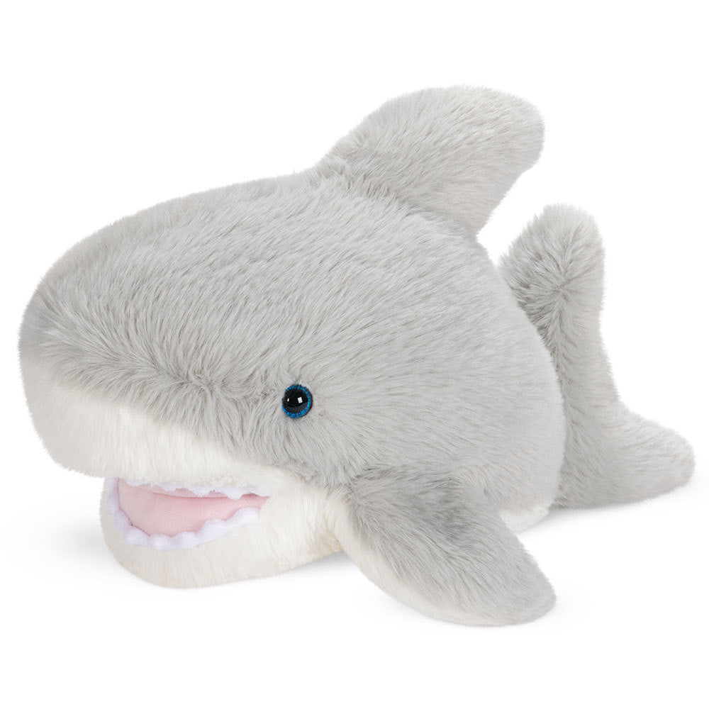 Plush light gray shark toy with soft fur, blue eyes, and an open mouth showing white fabric teeth.