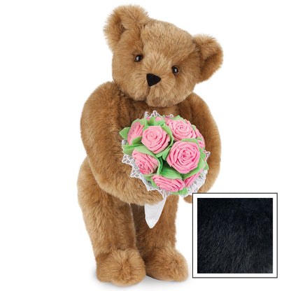 Brown teddy bear holding bouquet of pink roses with green leaves and white lace trim.