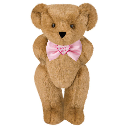 Honey brown teddy bear with brown eyes wearing a pink bow tie that says "It's a Girl!".